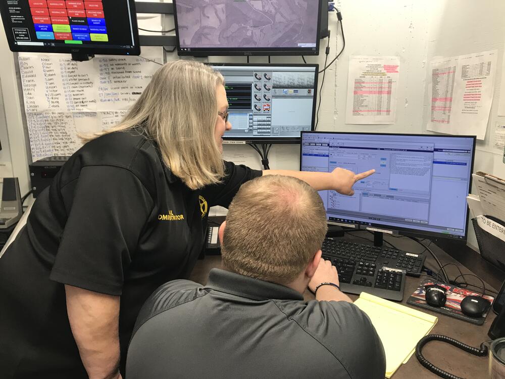 Searcy County Jail Administrator Tracy Sutterfield instructing Dispatcher/Detention Officer Blake Kelley on the use of the new CAD system upgrades on dispatch, booking and evidence used at the Searcy County Sheriff's Office.