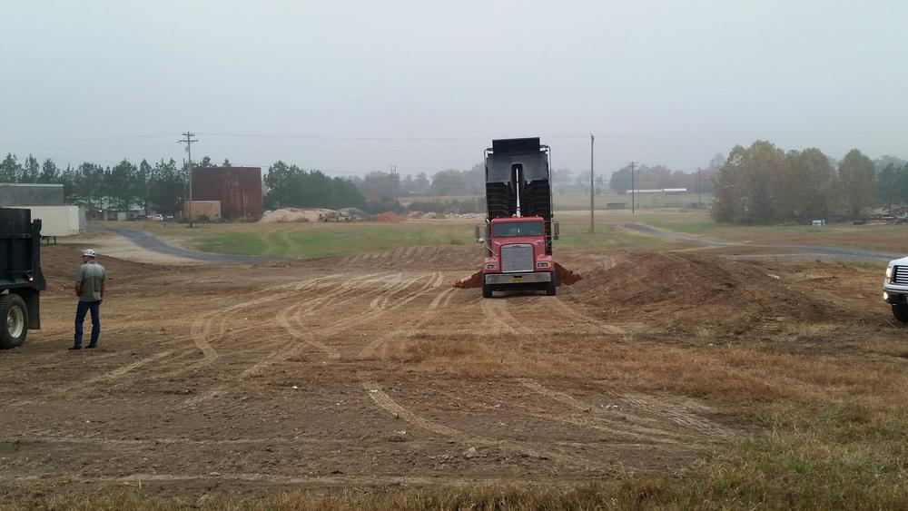 red truck dumping dirt