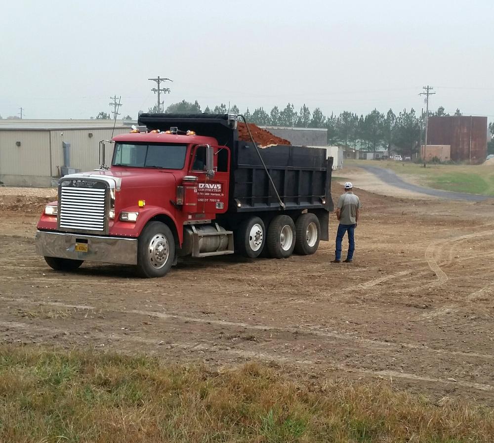 red truck side view with dirt